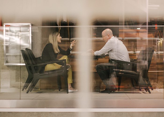 Canva - Man and Woman Sitting on Black Wooden Chairs